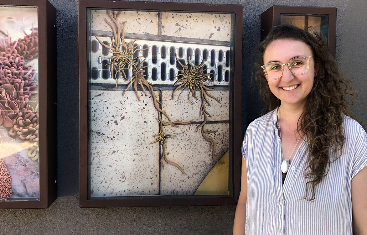 Artist Holly O'Meehan standing in front of her artworks at the Box Gallery in Manning