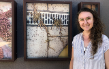 Artist Holly O'Meehan standing in front of her artworks at the Box Gallery in Manning