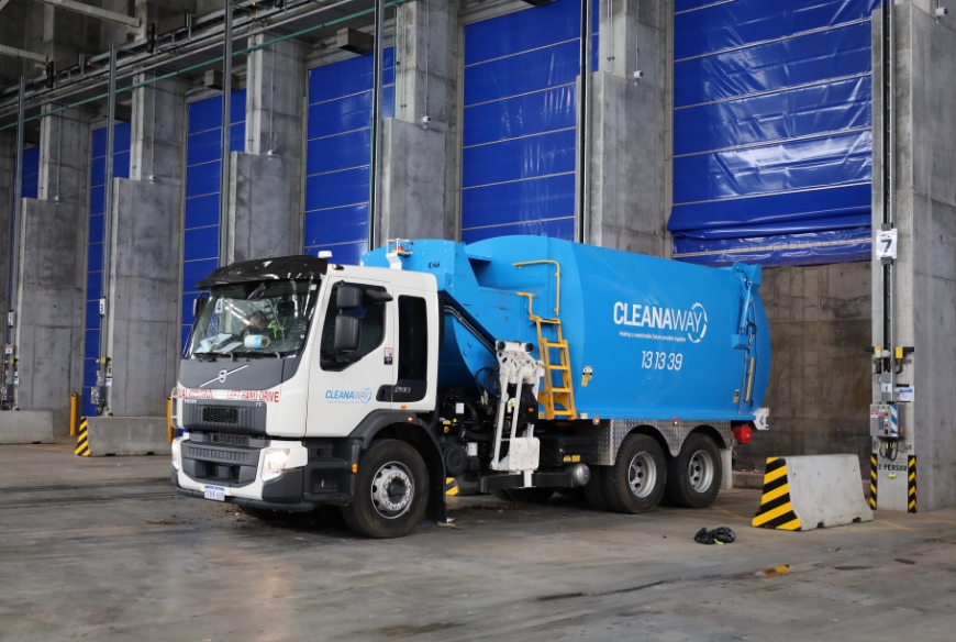 Blue waste truck with Cleanaway logo.