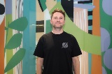 ChrisNixonstandinginfrontofhismuralatManningLibrary