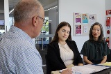 Ajobseekerandcareeradvisorlookingatnotesinanoffice