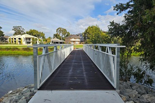 Awoodandmetalfootbridgeacrosswater