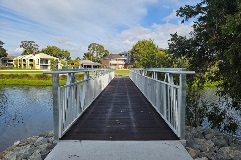 Awoodandmetalfootbridgeacrosswater