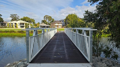 Awoodandmetalfootbridgeacrosswater