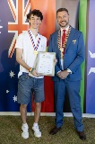 Two men smiling and holding a framed certificate.