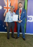 Two men smiling and holding a framed certificate.