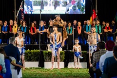 People on a stage in front of a crowd