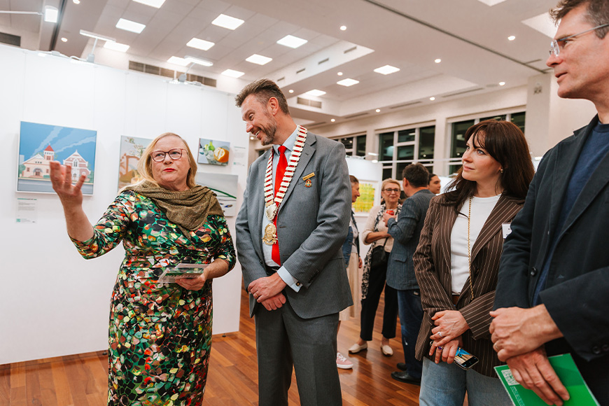 People talking in a busy gallery.