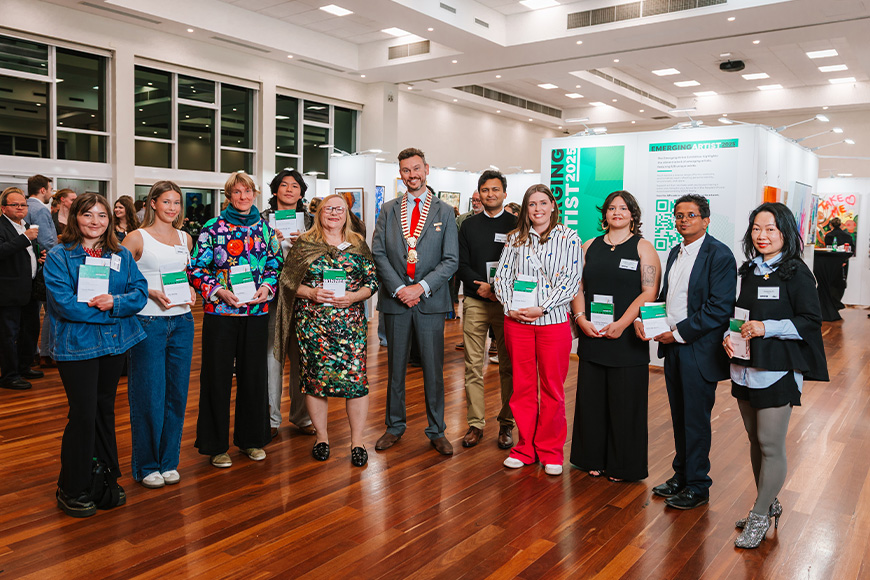 A group of people holding certificates and smiling at camera.