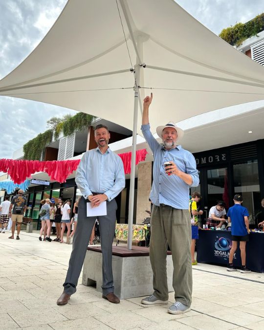 Mayor Greg Milner and local member Geoff Baker standing the umbrellas at the Manning Laneway Festival