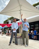 Mayor Greg Milner and local member Geoff Baker standing the umbrellas at the Manning Laneway Festival