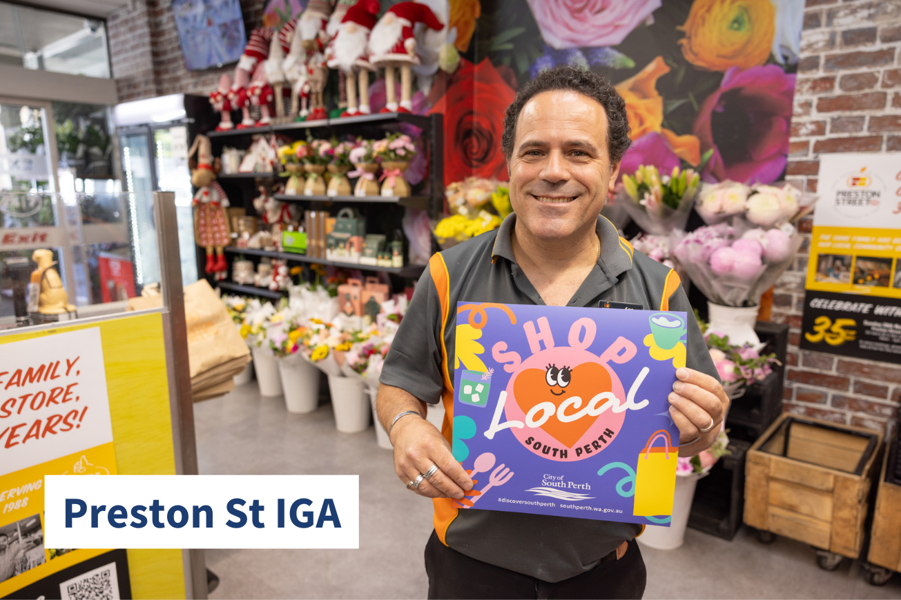 Image of man holding Shop Local sign at Preston St IGA