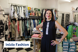 Woman smiles at camera in fashion store