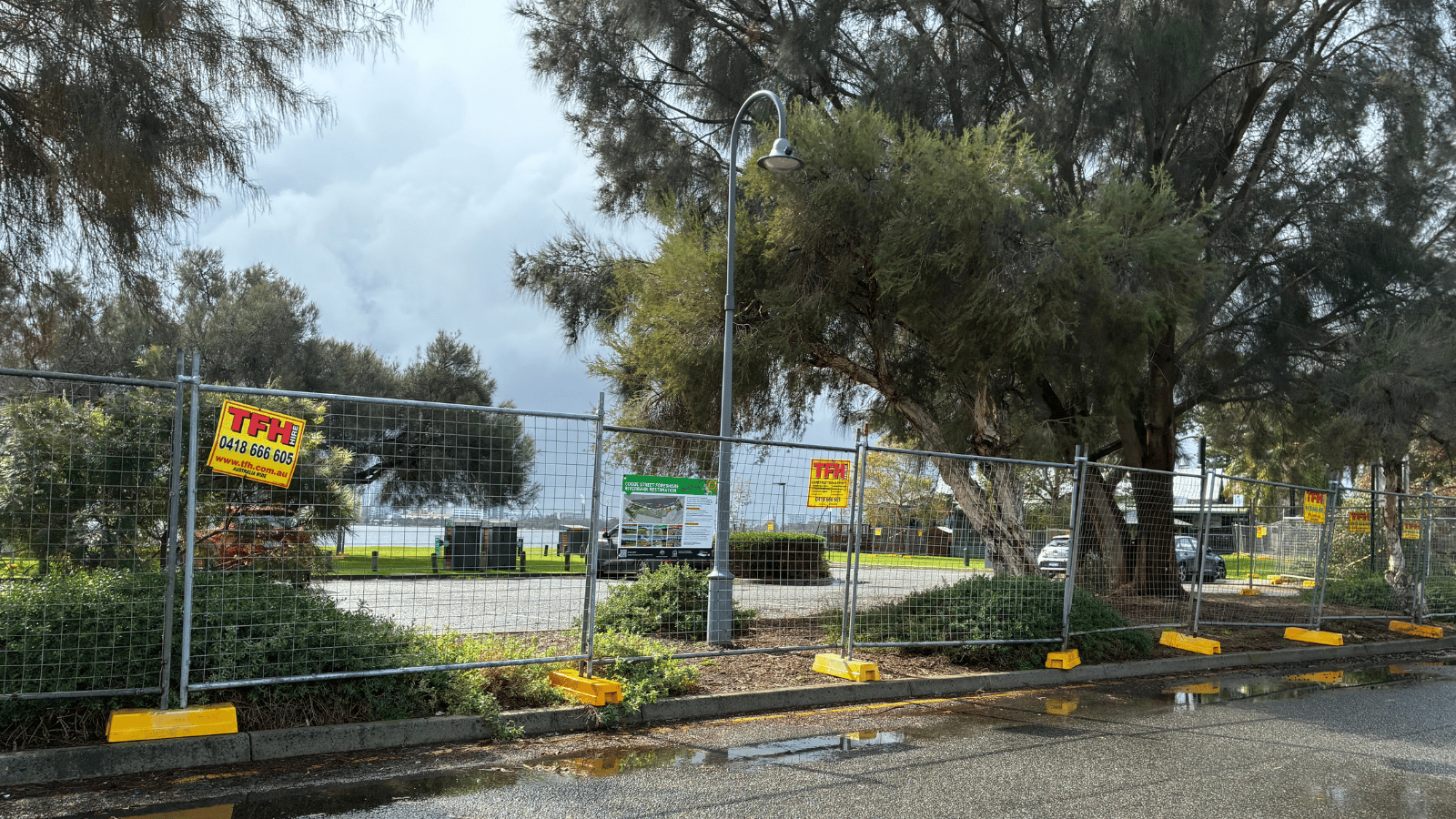 Temporary construction fencing in front of river foreshore