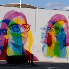 A wall mural comprising to close up portraits of girls with glasses in abstract colours.