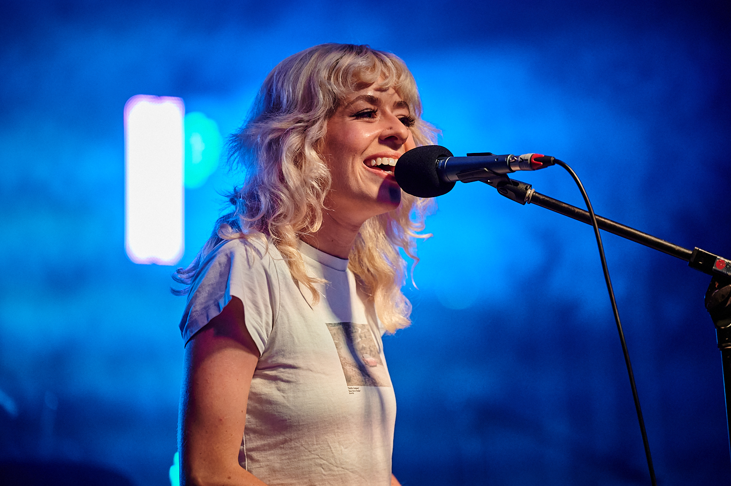 Singer performs into microphone at NEON Youth Festival 2023