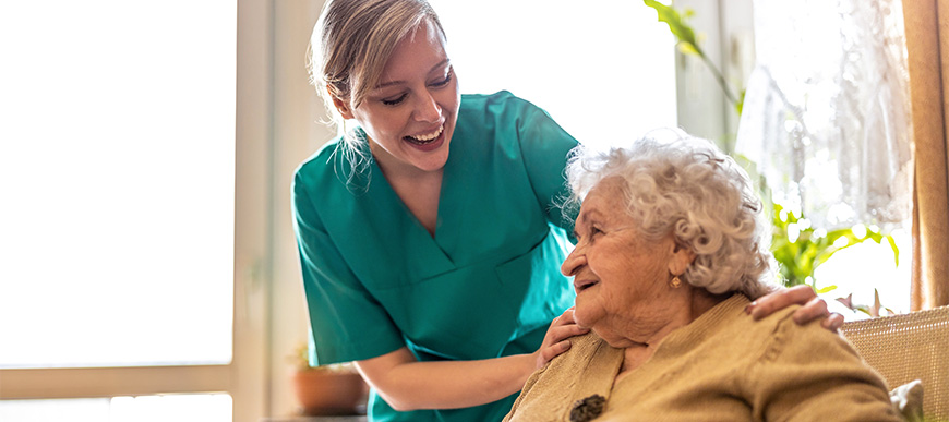 Elderly woman and support worke