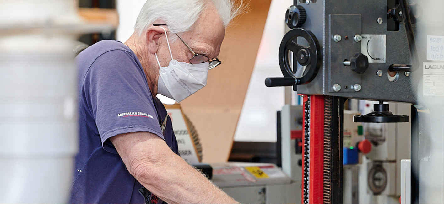 man working on shed project wearing mask