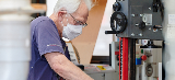 man working on shed project wearing mask