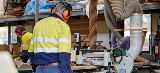 man wearing earphones working in a garage