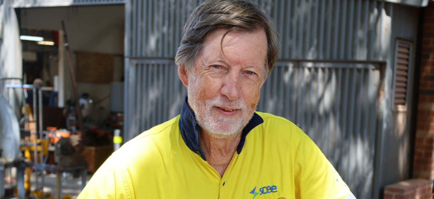 man wearing high vis clothing outside mens shed