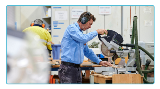 Personoperatingatablesawinaworkshopwearingearmuffs