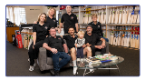Familyposeforphotographintheirgenerationalcricketretailstore