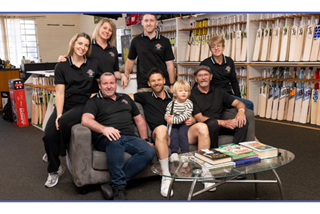 Familyposeforphotographintheirgenerationalcricketretailstore