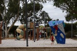 Children playing on new play equipment at Bill McGrath Reserve in Kensington