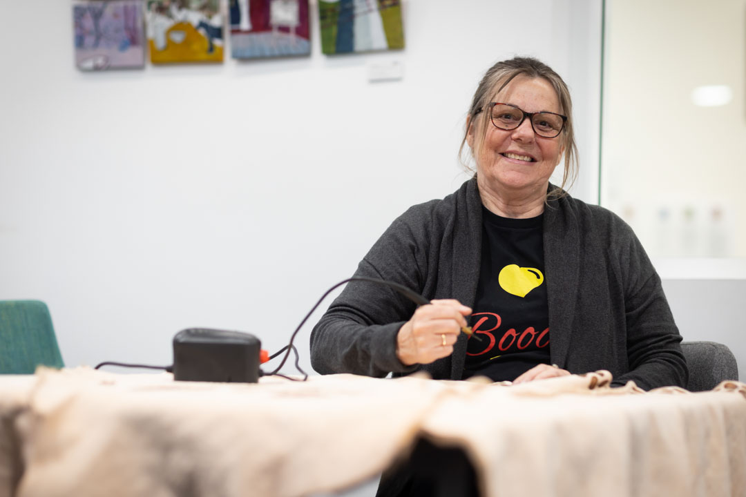Artist designing a kangaroo skin coat.