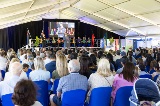 A crowd watching someone speak on stage.