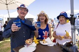 Three people eating breakfast and smiling.