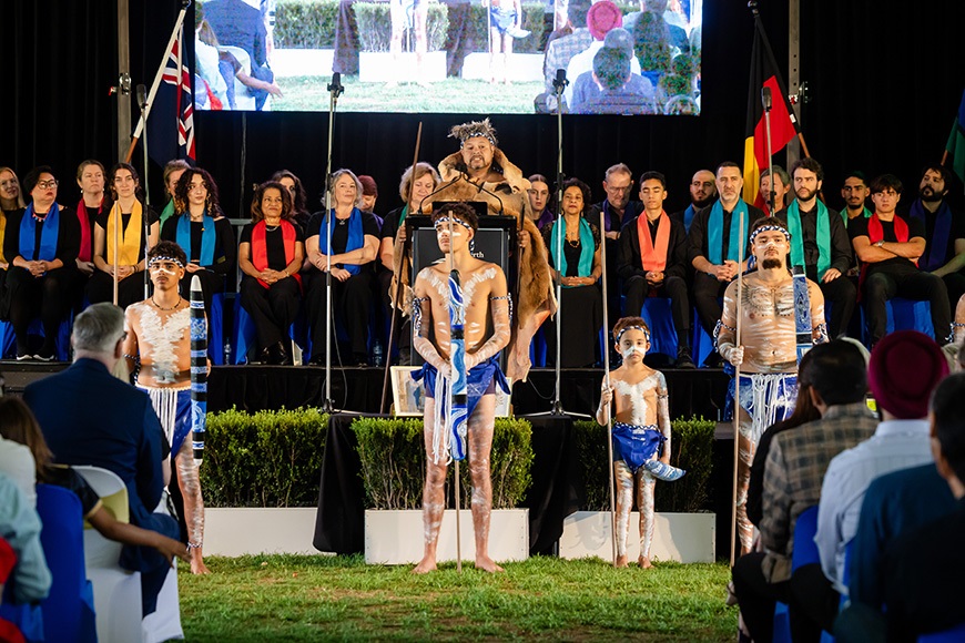 Anumberofpeopleonstageaddressingacrowd