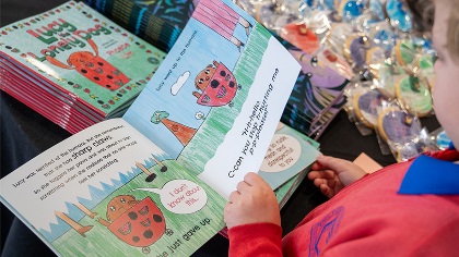 Achildreadingthroughacolourfulpicturebook