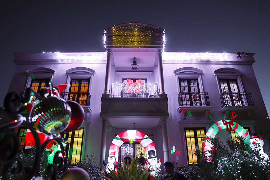 A two storey house covered in Christmas Lights and decorations