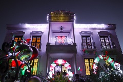 A two storey house covered in Christmas Lights and decorations