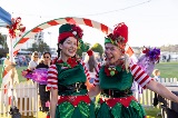 Twowomeninfestiveelfcostumessmilingatthecamera