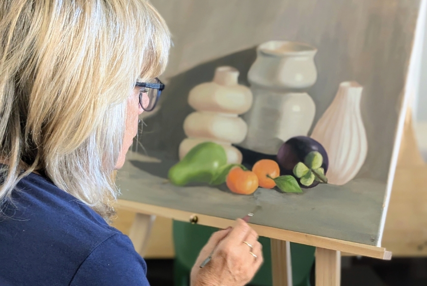 Woman painting still life