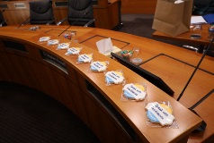 Council chamber bench lined with cookies with branding to celebrate 30th year of Speak with Confidence Awards.