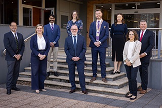 Agroupofninepeoplesmiling