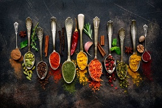 SilverspoonswithavarietyofIndianspices