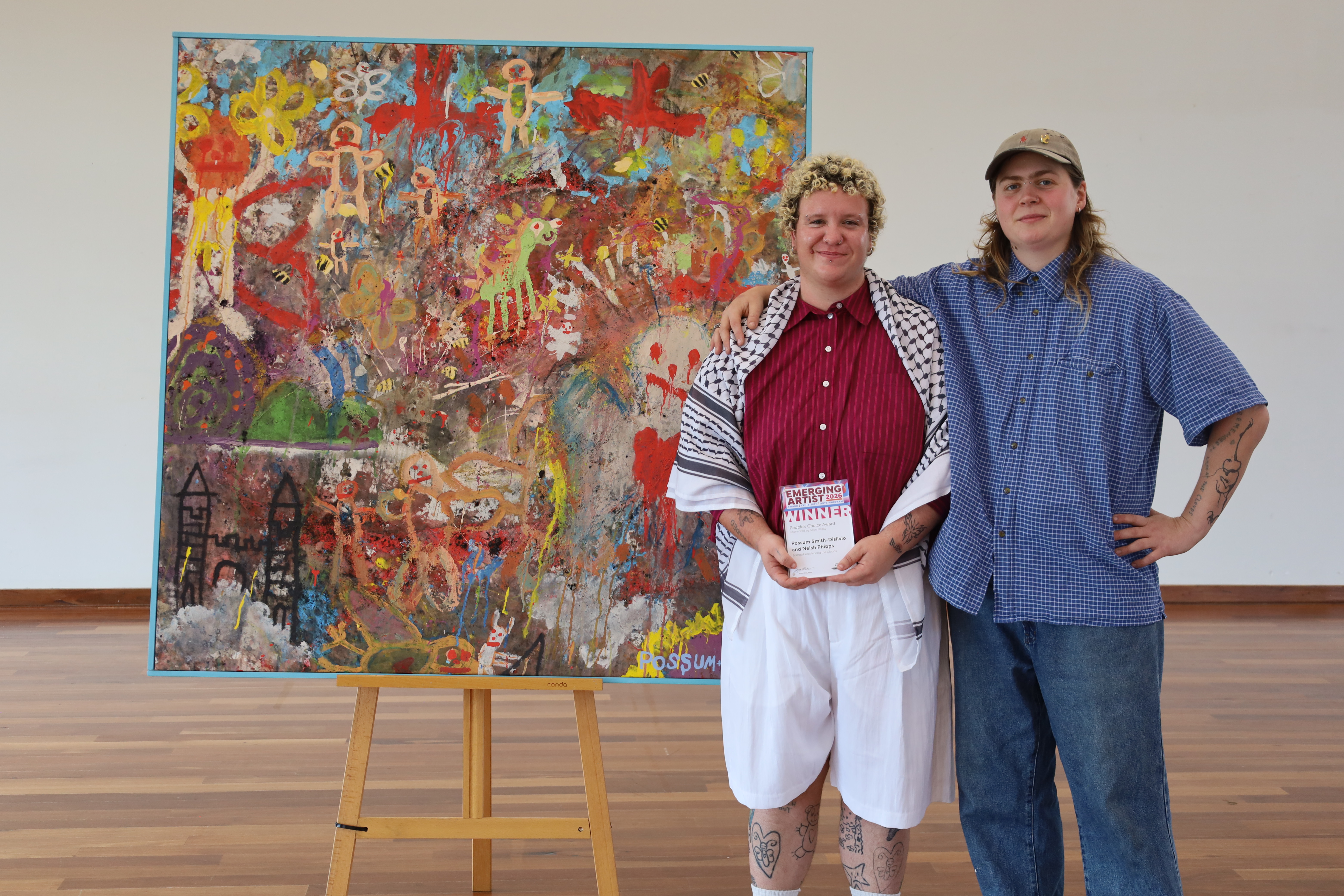 Two artists in front of their winning Emerging Artist People's Choice artwork.