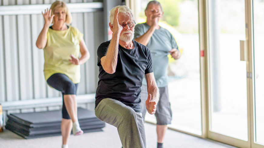 3peopleperformingataichiexerciseclass