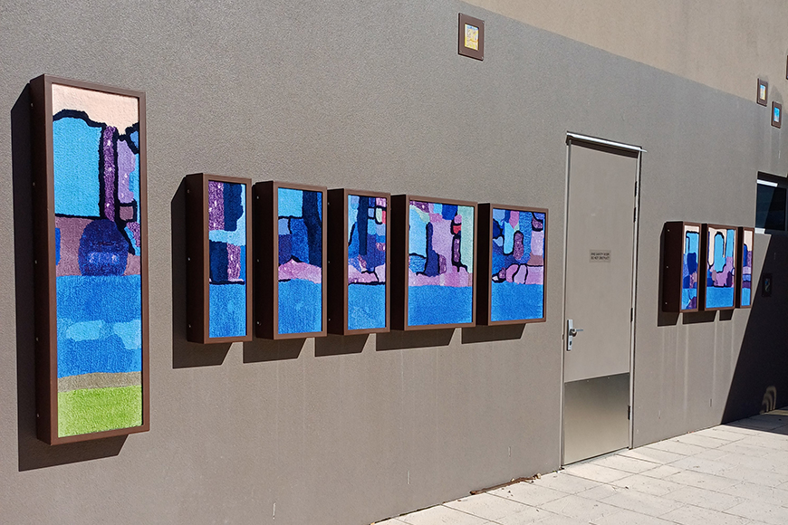 Colourful artworks on a wall.