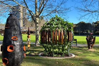 Whimsicalsculpturesinagrassedareaunderatree
