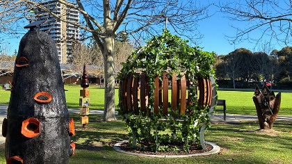 Whimsicalsculpturesinagrassedareaunderatree