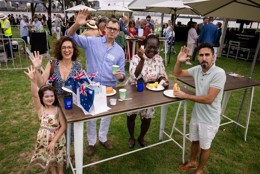 New citizens enjoying a sausage sizzle at the Big Aussie Breakfast