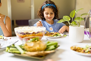 Alittlegirleatingatatable