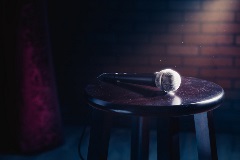 Amicrophonerestingonastoolunderaspotlight