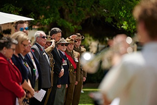 Agroupofpeoplelookingonasabugleplayerplays